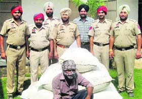 One of the accused with the seized poppy husk in police custody at Dehlon