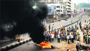 Protesters burn tyres against the bifurcation of Andhra Pradesh in Vijayawada on Friday. The YSR Congress Party is observing a 72-hour shutdown in the state. 