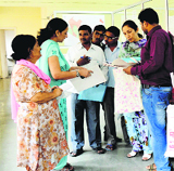 Residents fill forms for the regularisation of their properties at the Zone B office of the MC in Ludhiana on Friday. 