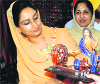 Bathinda MP Harsimrat Kaur Badal shows keen interest in an art work at an exhibition in Patiala on Friday. Tribune photo: Rajesh Sachar