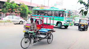 A bus takes a U-turn from a dismantled road divider near the canal office in Amritsar on Saturday. 
