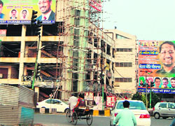 Hoardings and billboards of various parties being put up at Novelty Chowk in Amritsar on Saturday. 