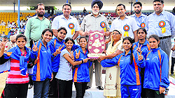 Winning teams pose for the shutterbugs with their trophies