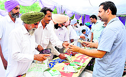Farmers make enquiries at the Kisan Mela in Bathinda on Saturday