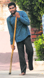 A differently abled man has a tough time visiting the shrine in the absence of golf carts.