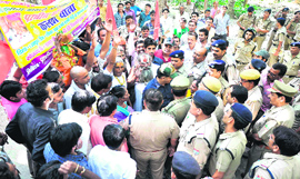 Devotees bound towards the shrine of Mata Chamunda Devi at Bilb mountain are stopped by the police and Rajaji National Park personnel near the Bilkeshwar Maha Dev temple in Haridwar on Saturday.