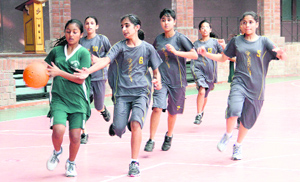 Players in action during a match in the DDCSA Junior Girls Inter-School Basketball Tournament in Dehradun on Saturday. 