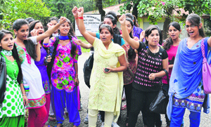 Girls protest against the administration on the Government College campus at Dharamsala on Saturday.