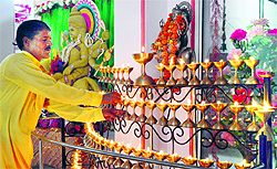 A priest lights 108 lamps on the first day of the Navratras at Durga Mata Mandir in Ludhiana on Saturday