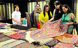 Visitors have a look at pashmina shawls during a lifestyle exhibition at Parka Plaza in Ludhiana on Saturday