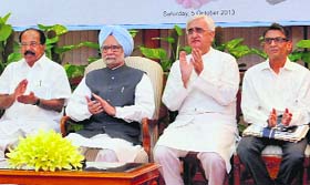 PM Manmohan Singh with Union ministers Salman Khurshid and Veerappa Moily at the inauguration of Bharat-Bangladesh Vidyut Sanchalan, through video link in New Delhi on Saturday.