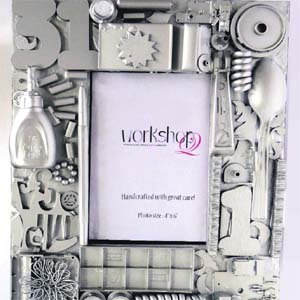 An intricately designed silver frame made from scrap from junkyard