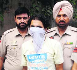 The police with a man arrested for drug peddling in Amritsar.