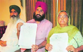 Dalbir Kaur and her sons show the death certificate of her husband issued by the Municipal Corporation in Amritsar on Sunday.