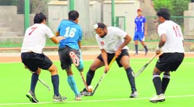 ONGC and IOC players in action during the final of the All India Public Sector Hockey Tournament in Amritsar on Sunday.