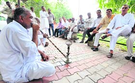 Haryana Congress workers rest outside the party office in Chandigarh on Sunday