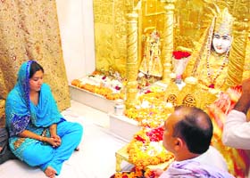 A devotee performs puja at the Mansa Devi temple on Sunday