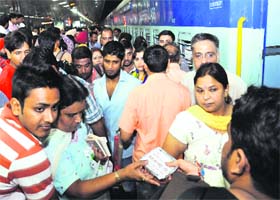 A devotee distributes food packets on the occasion at the Chandigarh railway station on Sunday