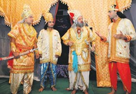 Nasir Ali (extreme right) and Shoaib Hussain (second from left) enact a scene from Ramlila at Sector 28 in Chandigarh on Sunday
