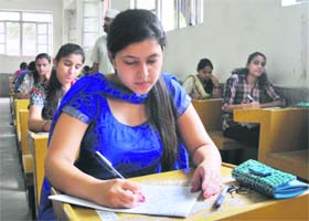 Students participate in the essay-writing event at the University of Jammu on Sunday