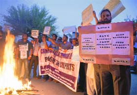 Doctors hold placards as they raise anti-government slogans during a protest against fake drugs scandal in Srinagar on Sunday