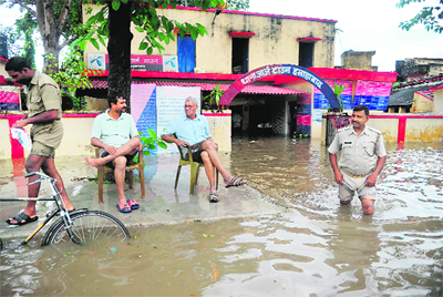 A policeman wades through floodwater in Allahabad on Saturday.