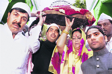 BJP leaders Vasundhara Raje Scindia and Shahnawaz Hussain carry a 'chadar' to offer at the shrine of sufi saint Khwaja Moinuddin Chishti in Ajmer on Sunday.