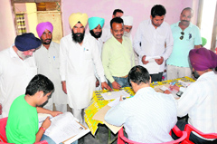 Applicants submit their documents for regularisation of their properties with officials at a camp set up by the Municipal Corporation, Bathinda (MCB) at Prajapat Dharamshala on Monday.