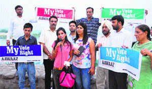 Members of Aawaaz, an NGO, during a campaign to spread awareness about voting rights at the Sukhna Lake in Chandigarh on Monday.