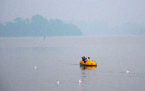 Visitors enjoy boating at the Sukhna Lake in Chandigarh on Monday.