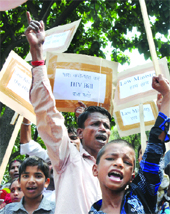 People, including children, protest outside the law ministry, demanding the tabling of the HIV/AIDS Bill in Parliament in New Delhi on Monday. 