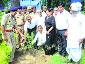 Dr Aditya Arya (3rd from left) and DIG Surej Bhan Kajal plant a sapling at Government Girls' Senior Secondary School in Murthal. 
