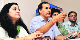 Jammu University Teachers Association members address a press conference in Jammu on Monday.