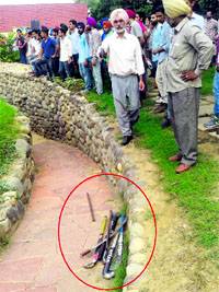 PAU security officer RS Grewal (in pink turban) shows the sharp-edged weapons confiscated from students on the PAU campus in Ludhiana on Monday.