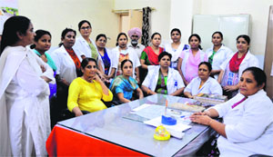 The nursing staff meet to discuss the tranfer of their colleagues at Lord Mahavir Civil Hospital in Ludhiana on Monday.