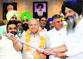 SAD leader Prem Singh Chandumajra felicitates the newly appointed Industies Minister Madan Mohan Mittal in Chandigarh on Monday