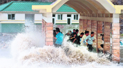 People run for safety as Typhoon Fitow hits Zhejiang province of China.  Reuters