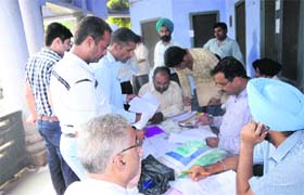 Applicants wait for their turn to submit their applications for regularising their properties situated in unapproved colonies in Amritsar