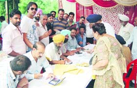The House Tax Department of the MC conducts an awareness camp of the property tax at Basant Avenue in Amritsar on Tuesday