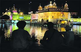 Divine lighting: The Golden Temple illuminated on the eve of the birth anniversary of Guru Ram Dass in Amritsar on Tuesday