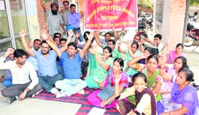 Members of the NRHM Employees Union stage a dharna during the second day of their agitation outside the office of the Civil Surgeon in Bathinda on Tuesday.