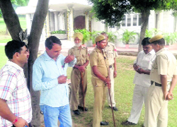 A team of wildlife officials conducts investigations into the killing of a snake at the Mansa Devi temple, on Tuesday.