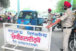 The police stops vehicles from entering a damaged bridge at Jagatpura village on Tuesday. 