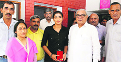 Savita Punia, the award-winning Indian women hockey team goalkeeper, with Chief Minister Bhupinder Singh Hooda in Chandigarh on Tuesday. A Tribune photograph