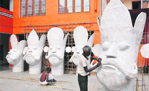 Workers busy preparing effigies of Ravana ahead of Dasehra in Jammu on Tuesday. 