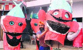 An artist carries an effigy of Ravana ahead of the Dussehra festival in Jalandhar on Tuesday.