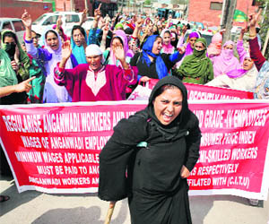 Anganwari workers stage a protest in support of their demands in Srinagar on Tuesday.