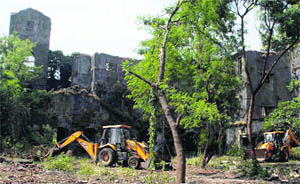 Public Works Department personnel demolish dilapidated structures and clean up the Shakti Mill compound in Mumbai on Tuesday. 