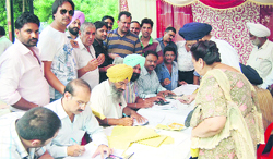 The House Tax Department of the MC conducts an awareness camp on property tax at Basant Avenue in Amritsar on Tuesday. Photo: Sameer Sehgal