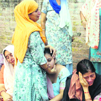 Inconsolable family members of hawker Parkash Chand Sharma, who died in a road mishap, in Amritsar on Wednesday. Photo: Sameer Sehgal
